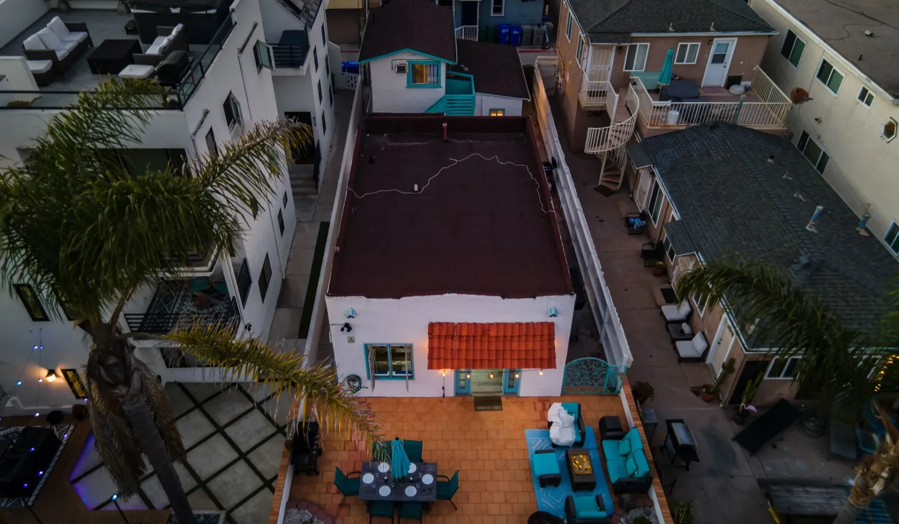 An aerial view shows a small patio with seating beside a building.