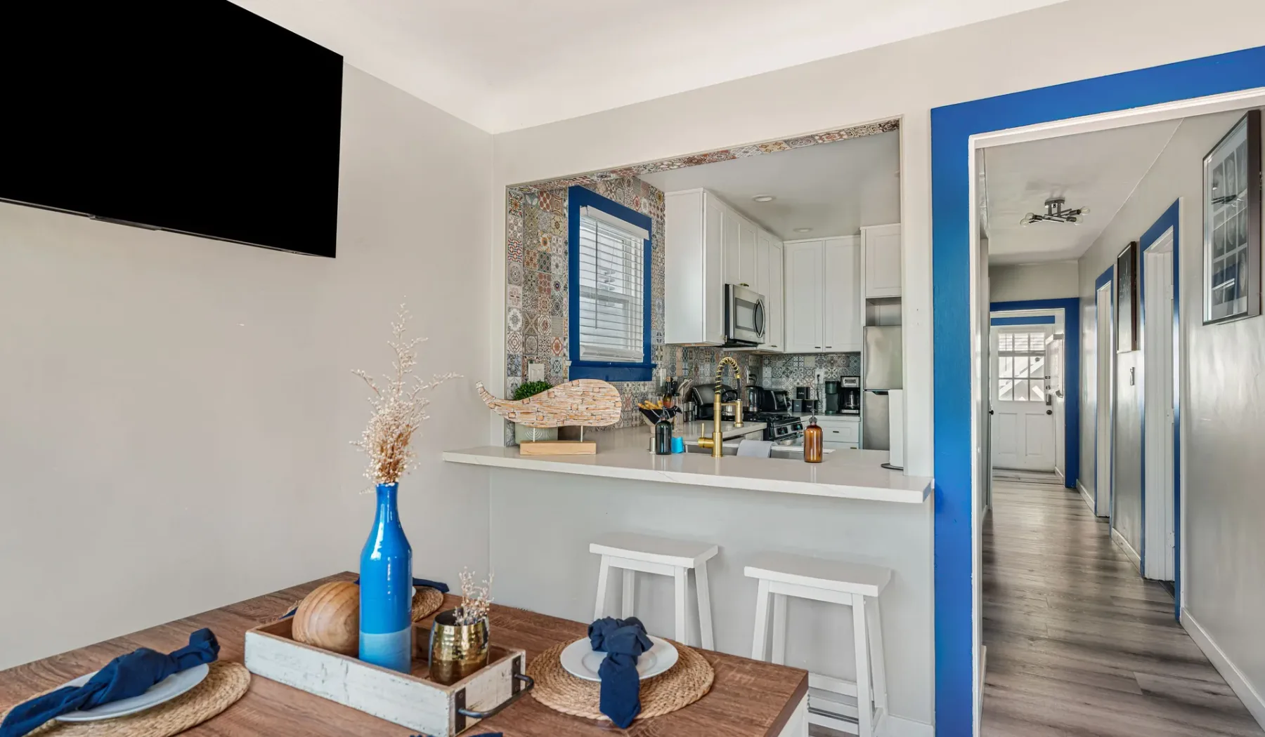 A dining area opens onto a kitchen and a hallway.