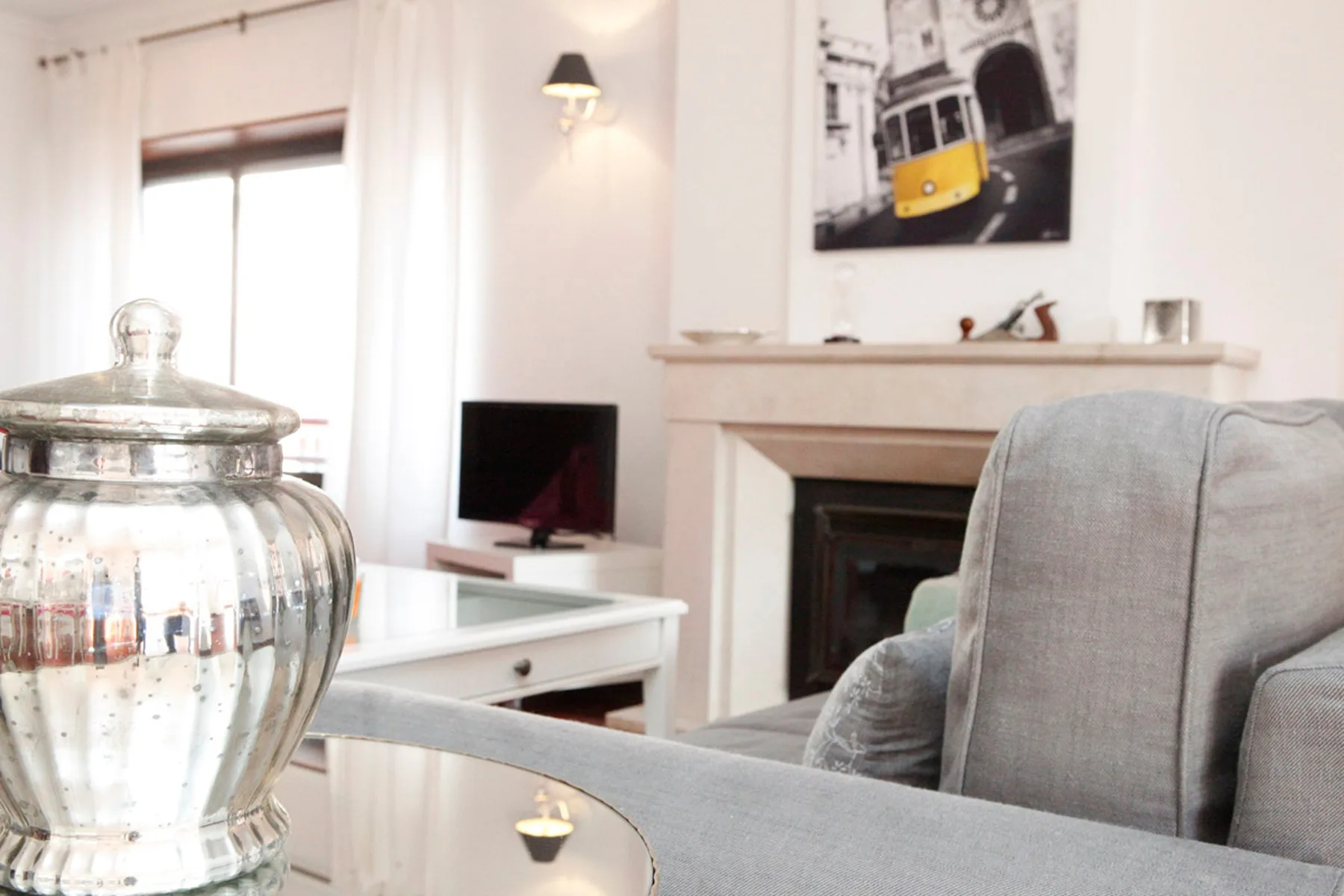 Un salón luminoso con asientos, una chimenea y un televisor.