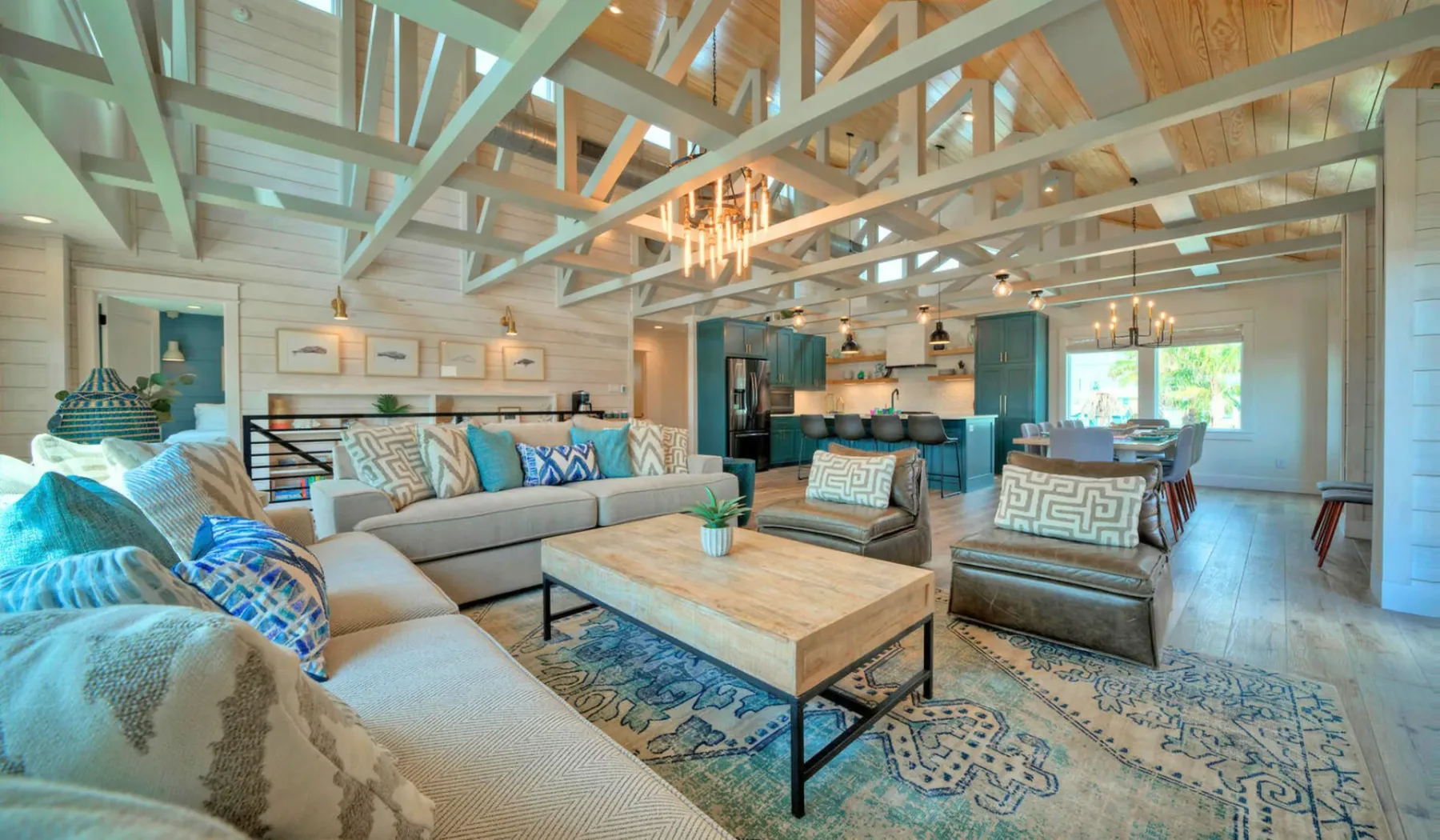 A bright open-plan living and dining area with seating arranged around a coffee table.