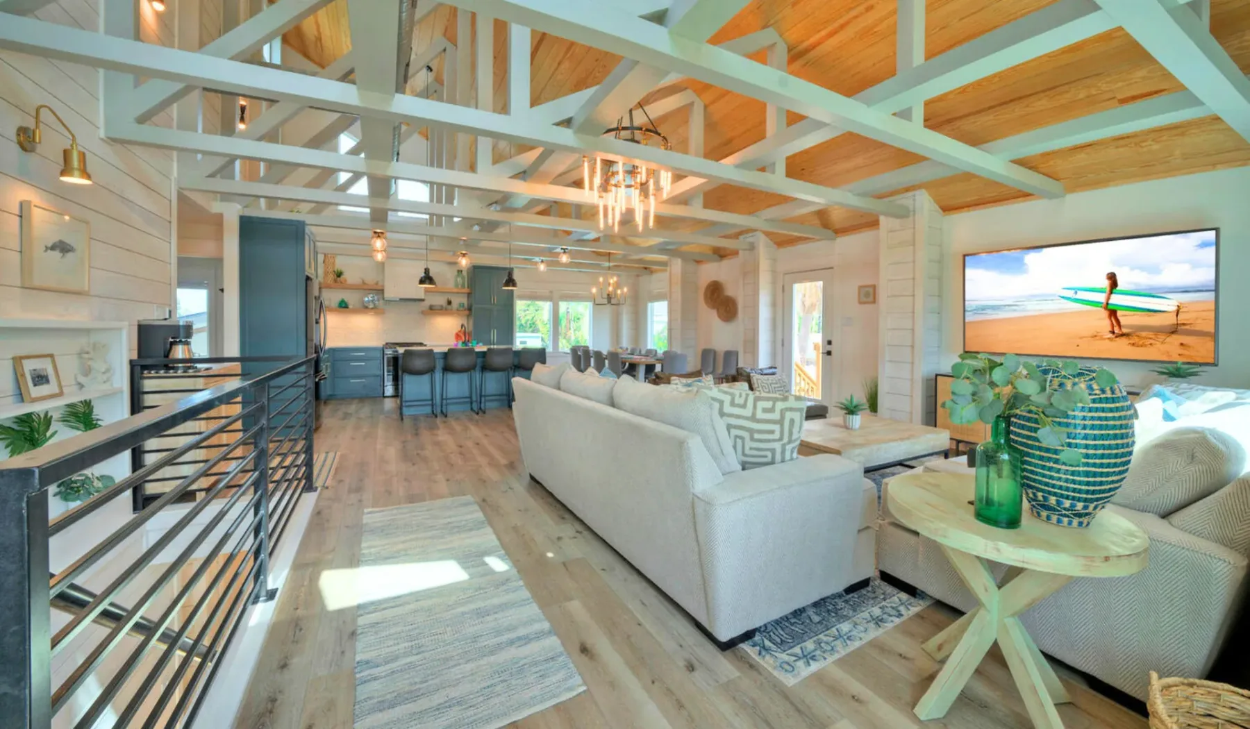 An open-plan living room with a seating area, dining space, and kitchen.