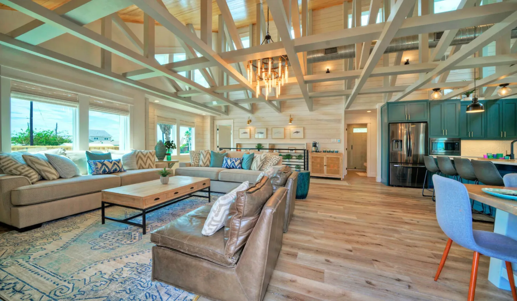 An open-plan living room and kitchen with seating around a coffee table.