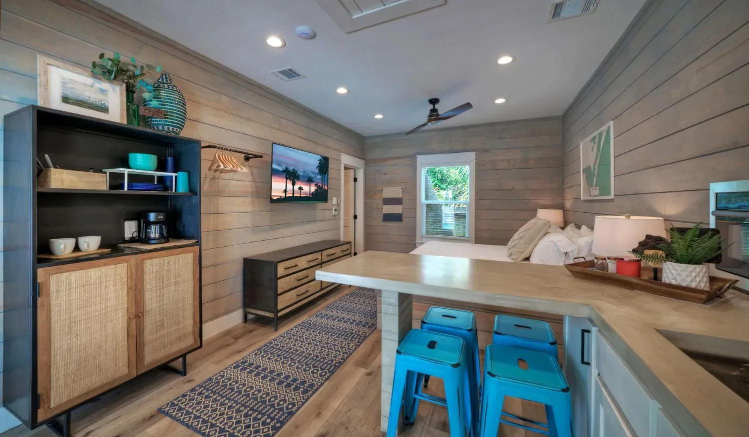 A wood-paneled room with a long table and blue seating.