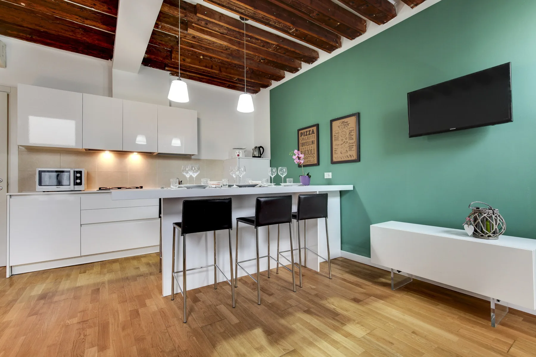 An open kitchen and dining area with a counter and stools.