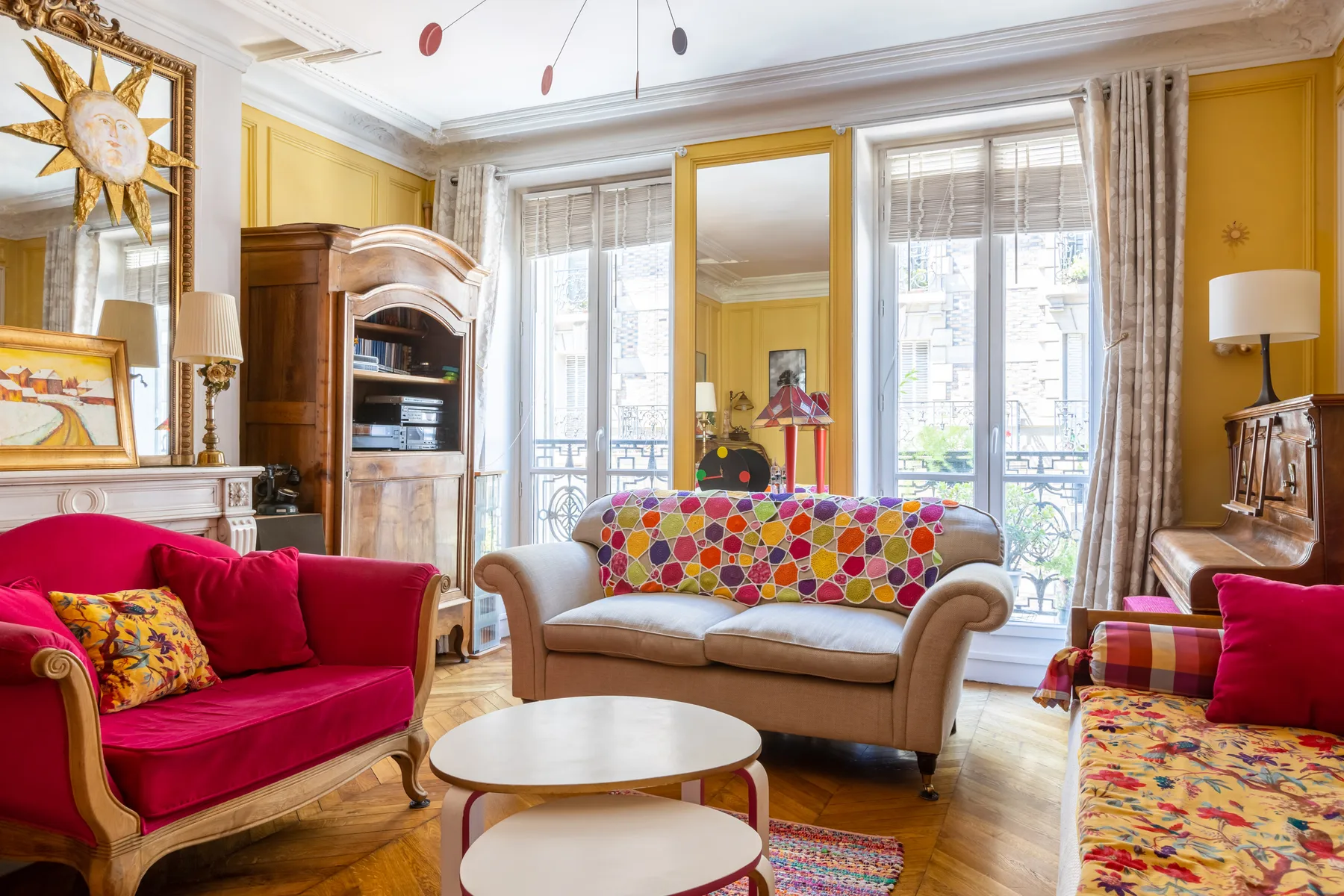 Una sala colorida con asientos rojos y ventanas altas.