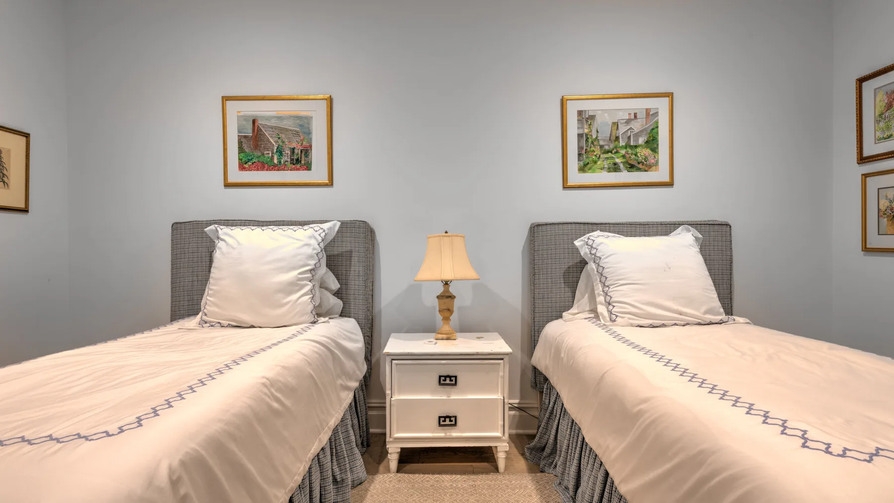Un dormitorio con dos camas individuales y una mesita de noche entre ellas.
