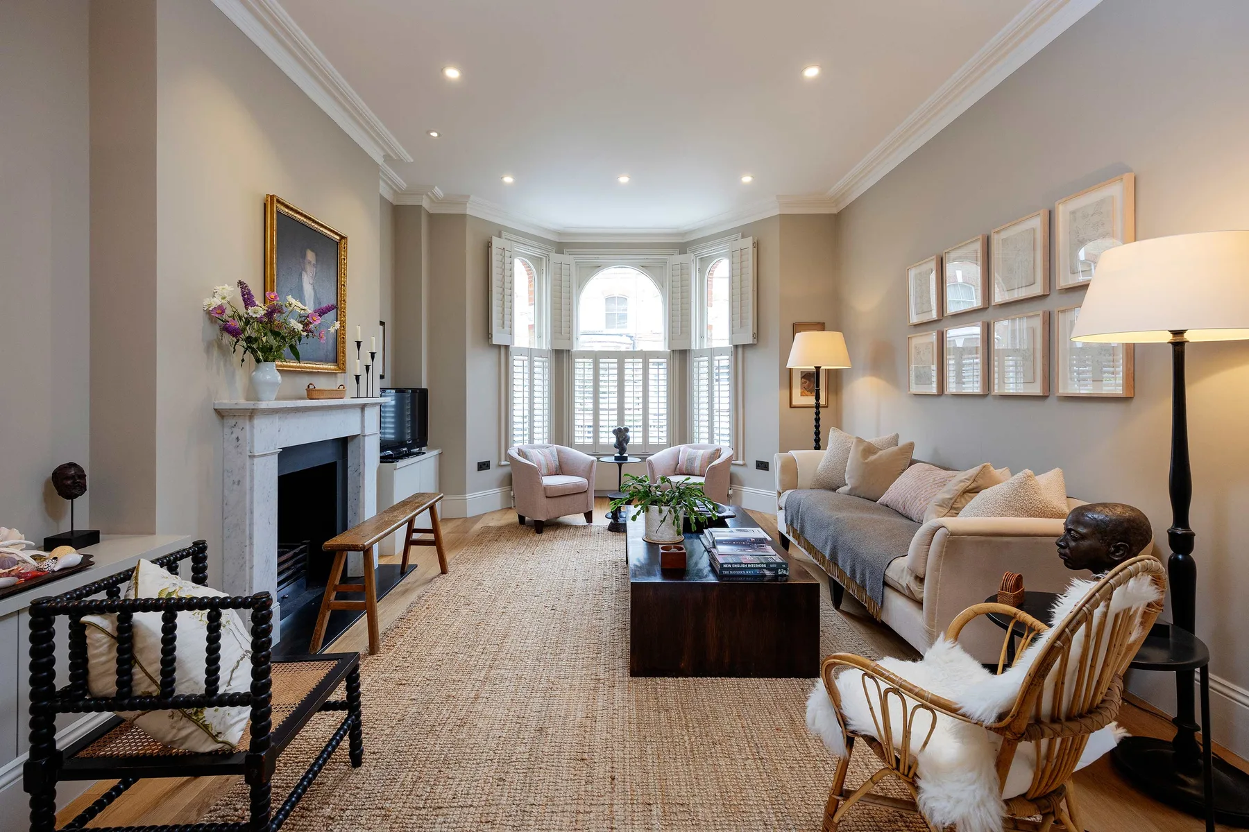 A bright living room with seating arranged around a coffee table.