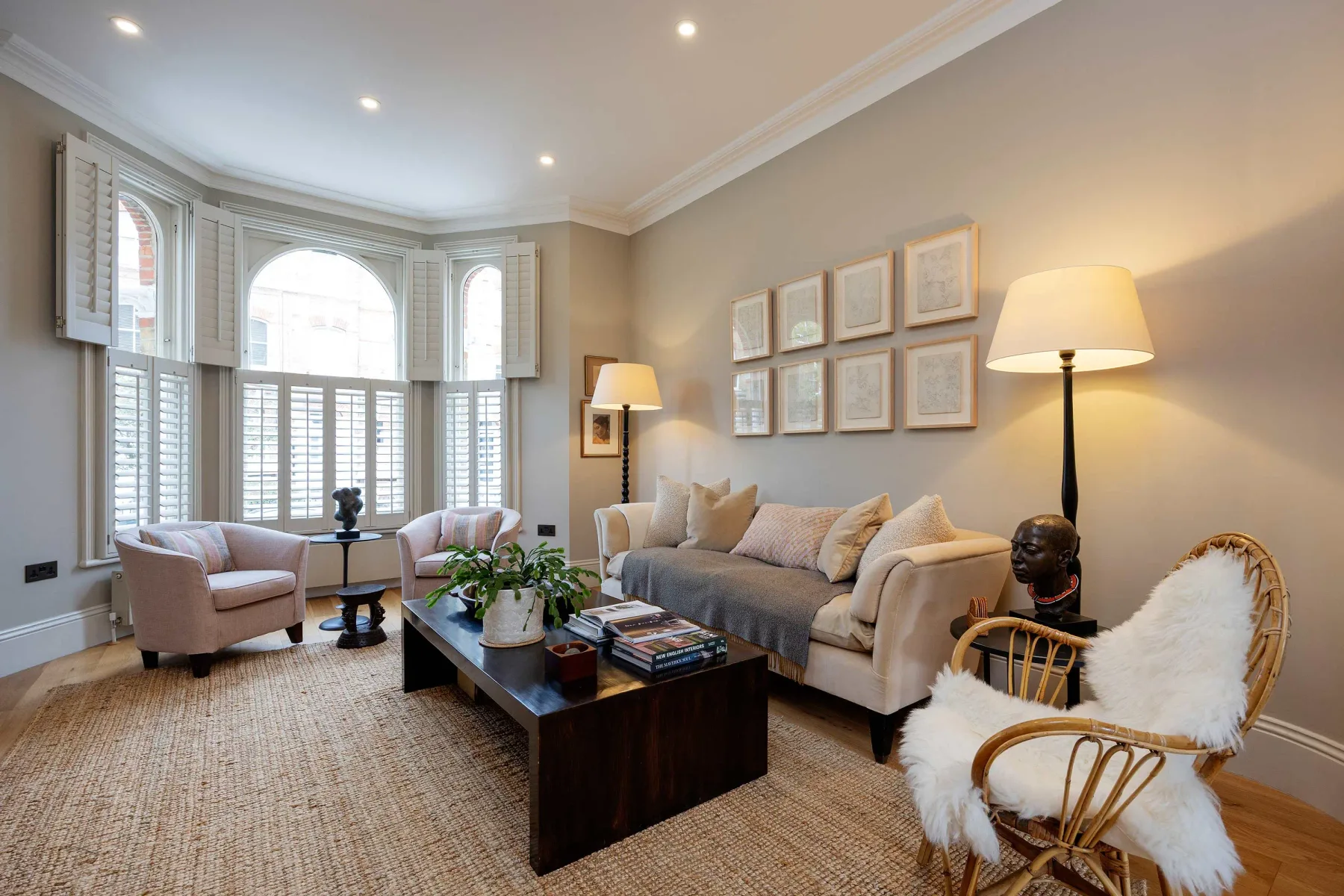 A bright living room with seating arranged around a coffee table.