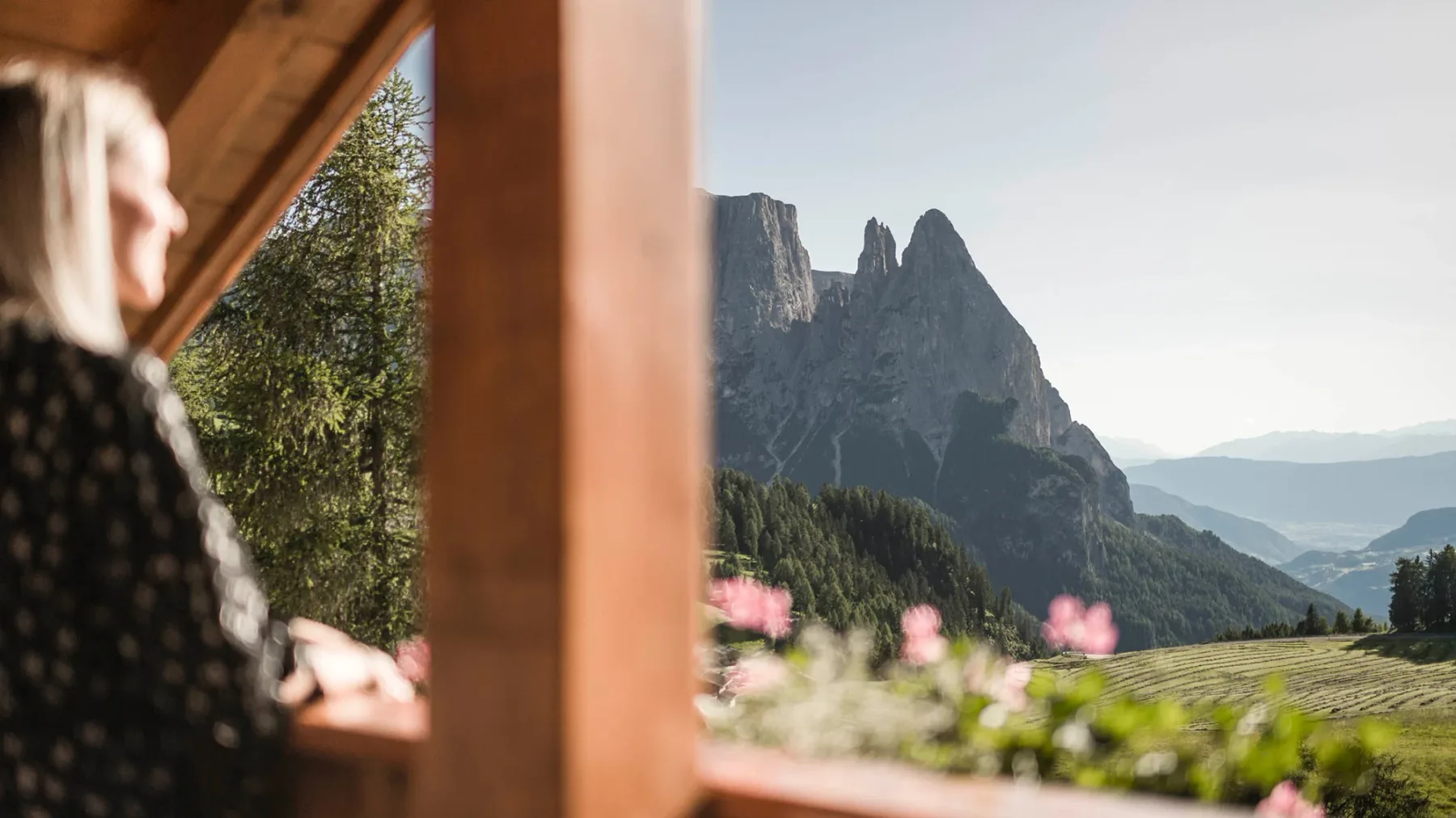 View of the Dolomites from a wooden balcony.