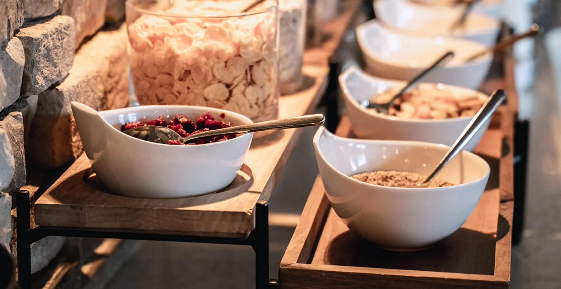Breakfast buffet with fruit and cereals.