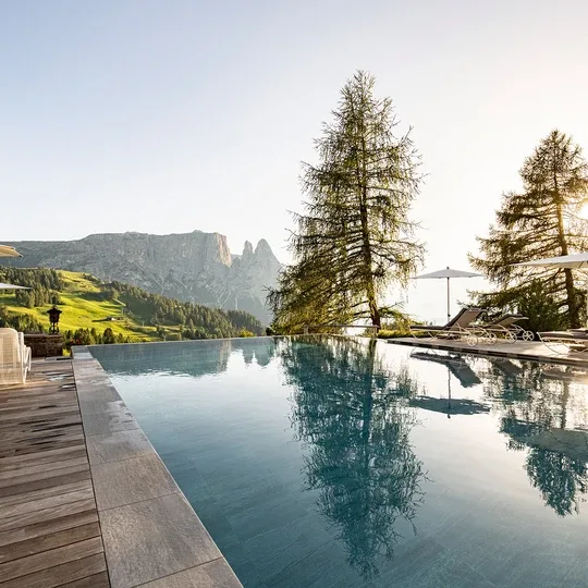 Outdoor infinity pool and sun loungers.