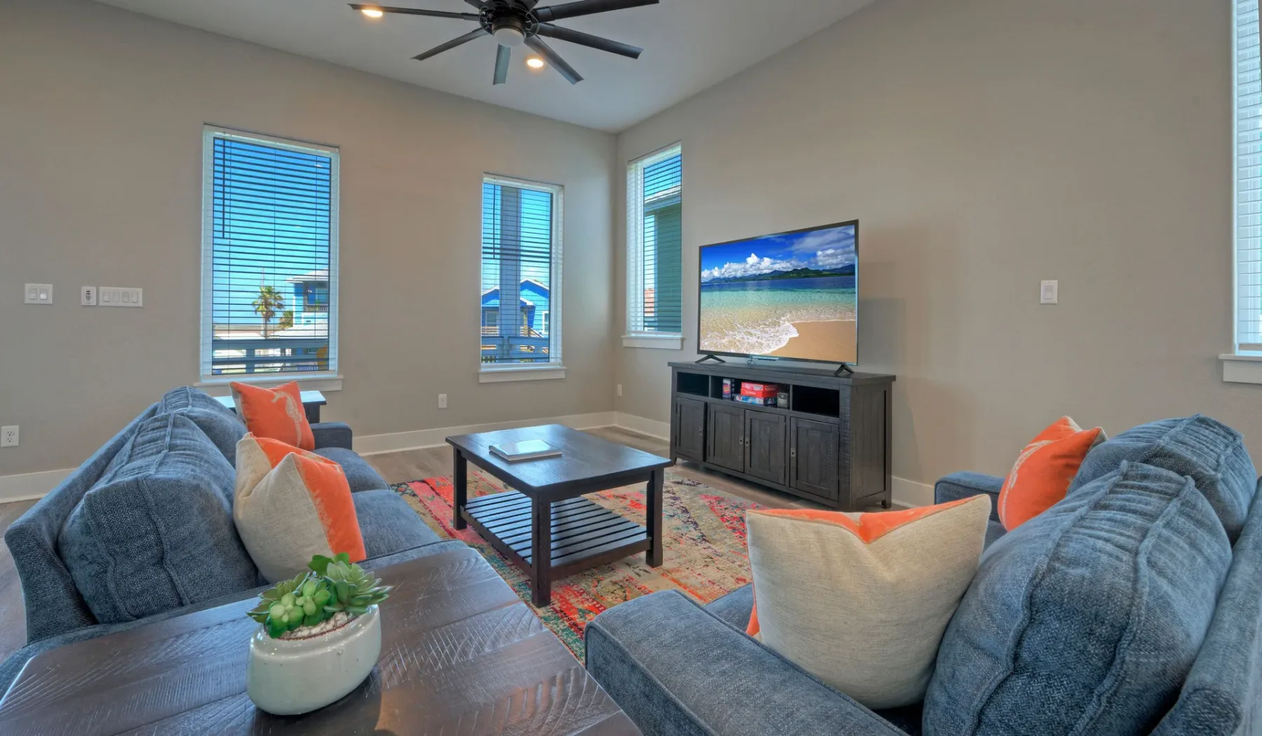 Living room with seating, a coffee table, and a television.
