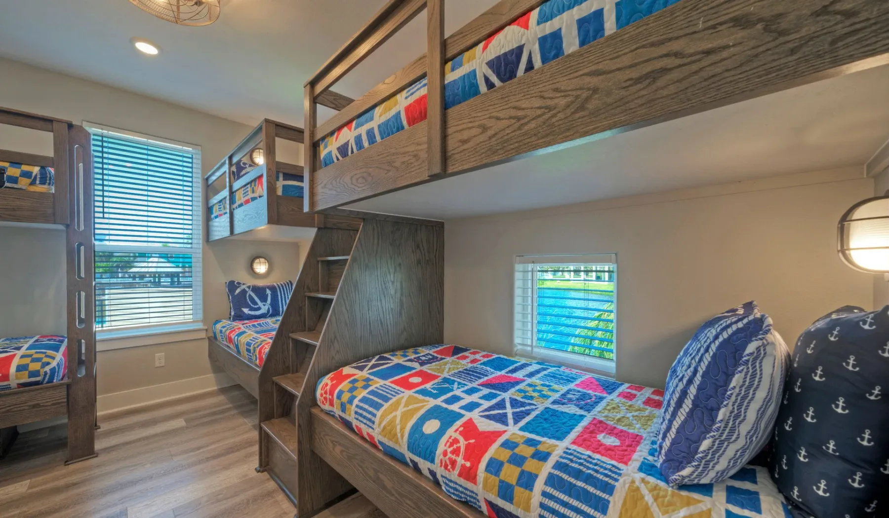 A bedroom with bunk beds dressed in colorful patterned bedding.