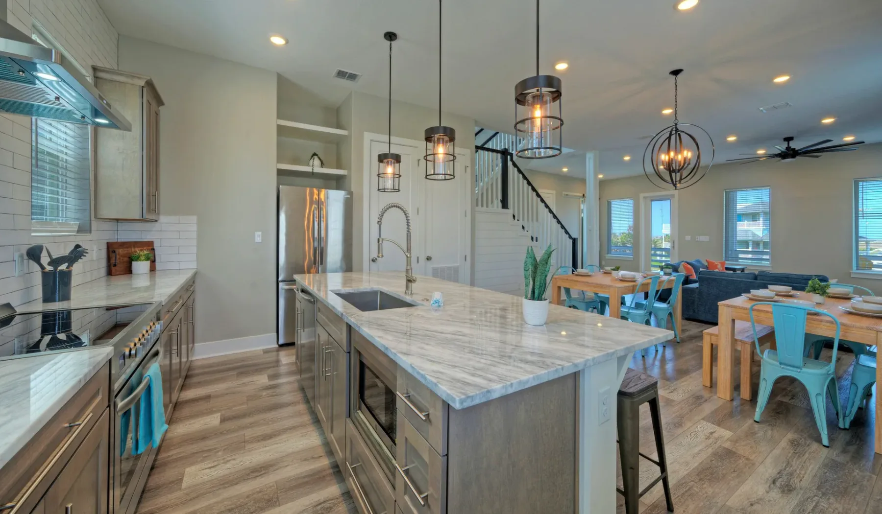 An open-plan kitchen and dining area with a large island and adjoining living space.