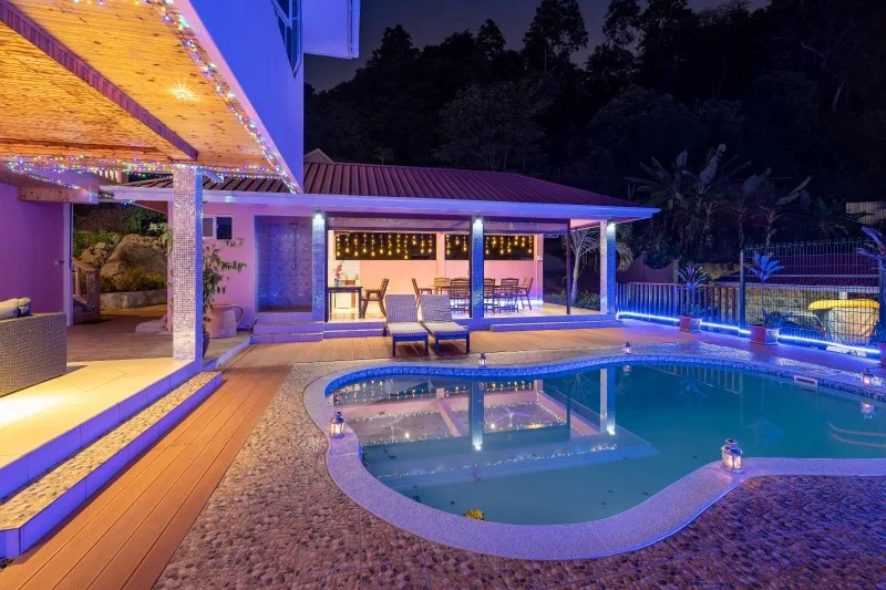 Swimming pool at night with sunset