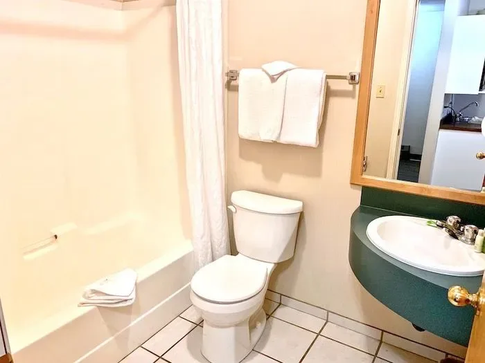 Room 27 bathroom with tub, sink and toilet.