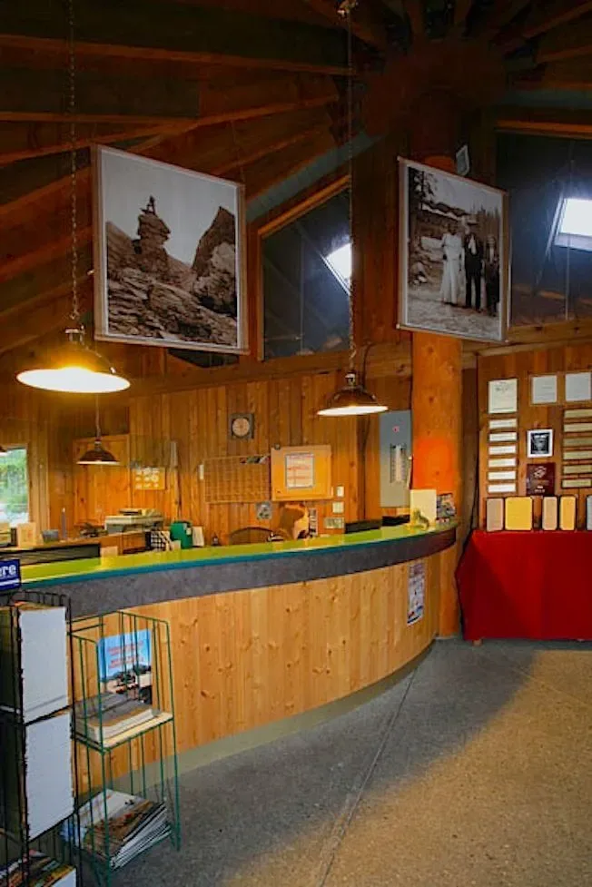 Interior lobby counter with wall photos and pendant lights.