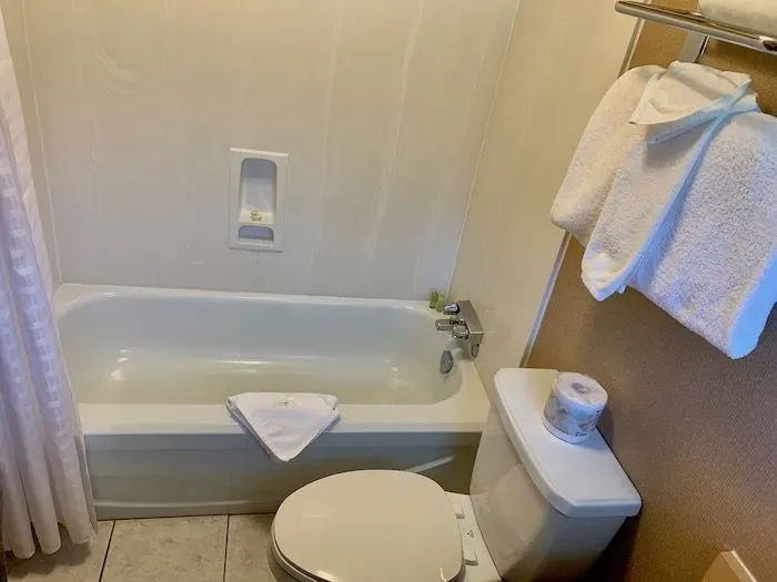 Private bathroom with bathtub and toilet.