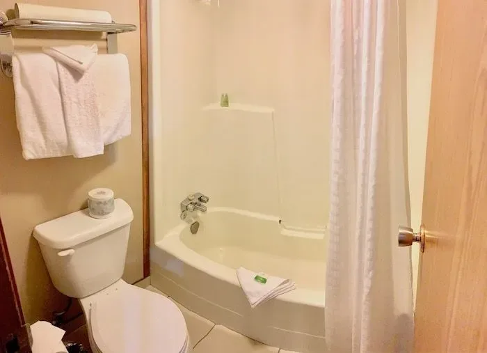 Guest bathroom with bathtub and toilet.