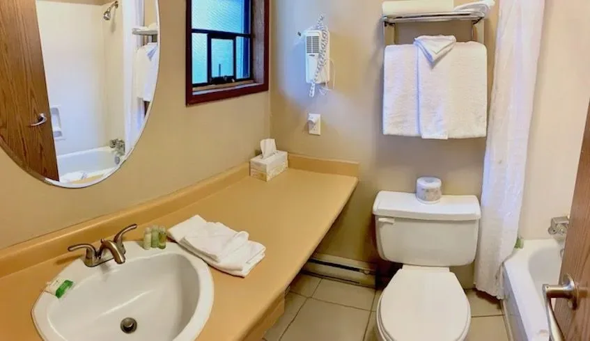 Guest bathroom with sink, toilet and bathtub.