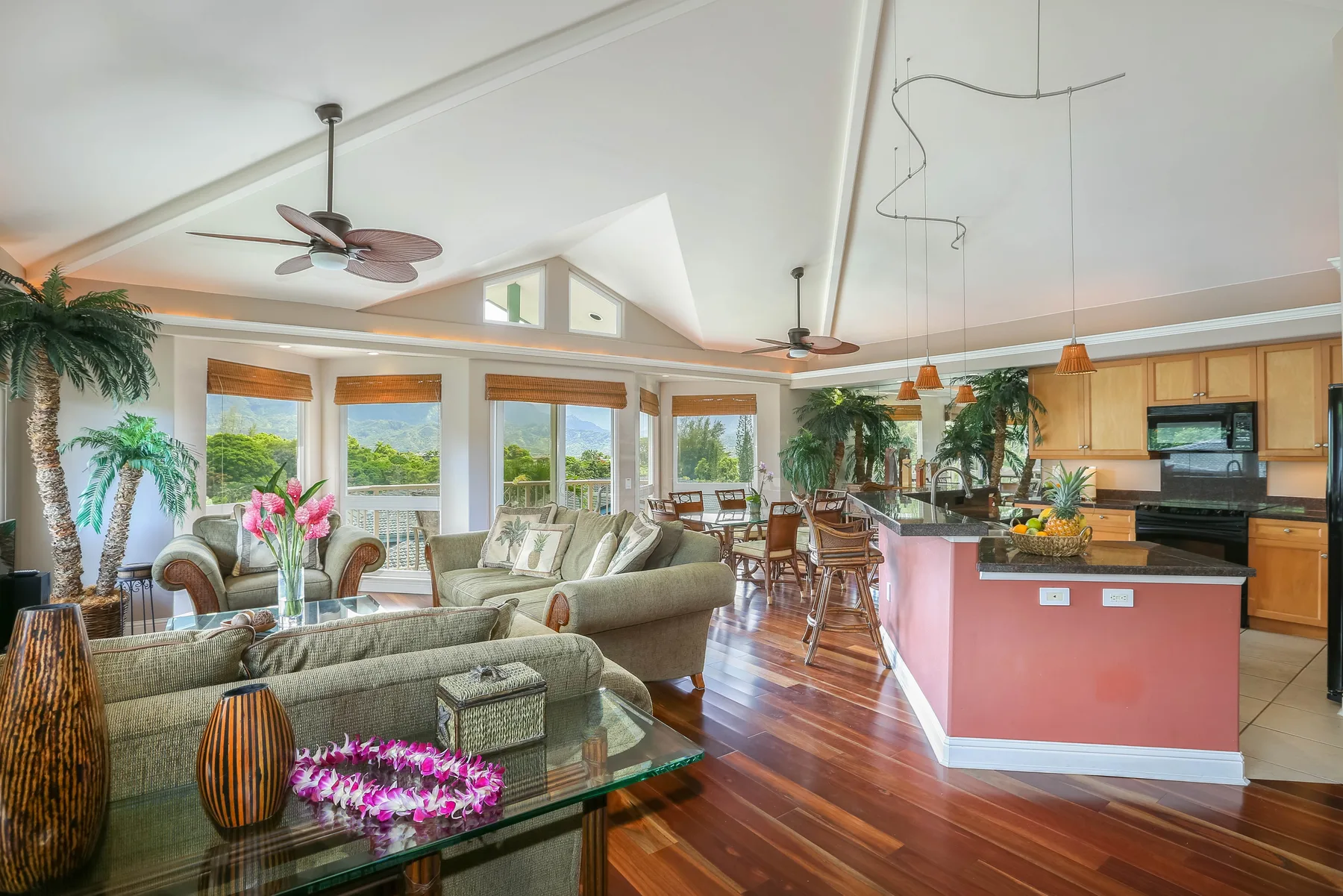 Open-plan living and dining area with a kitchen and large windows.