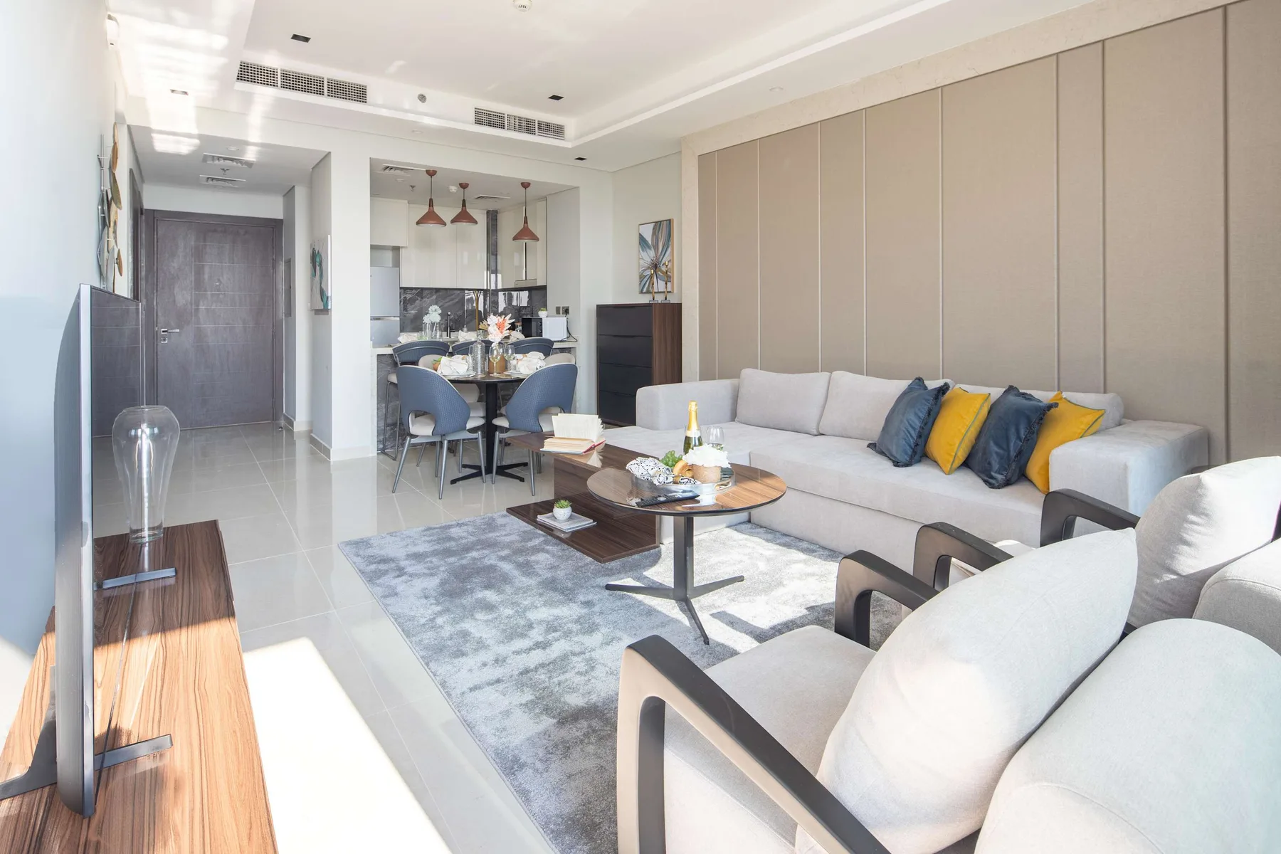 A bright living room with a sectional sofa, armchairs, and a coffee table.