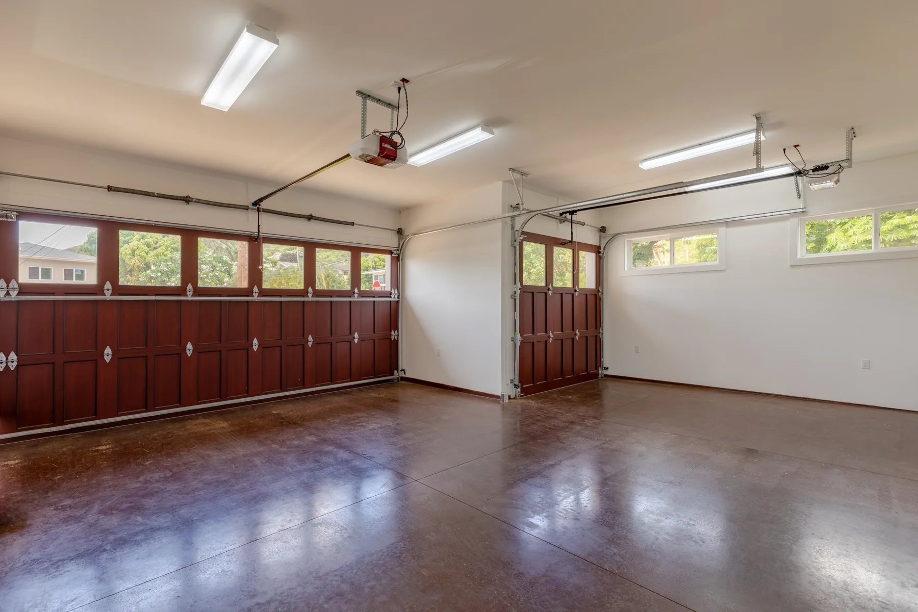 A spacious garage with wooden doors and polished flooring.