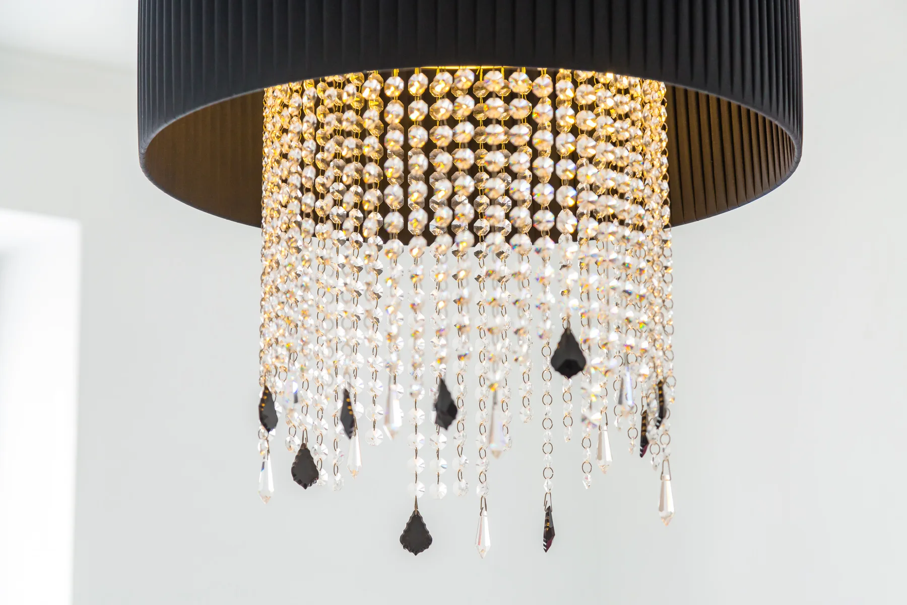 A decorative chandelier hangs against a bright white interior.
