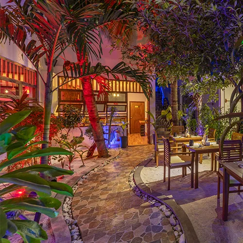 Kamadhoo Inn restaurant garden area at night.