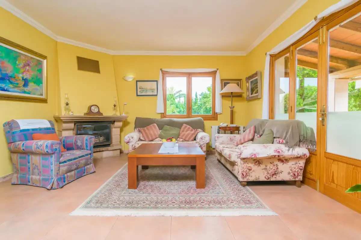 A living room with seating arranged around a wooden coffee table.