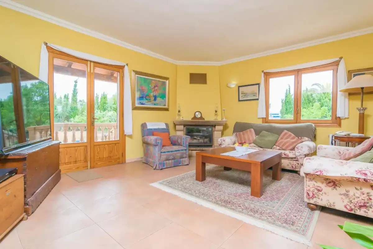 A living room with seating around a wooden coffee table.
