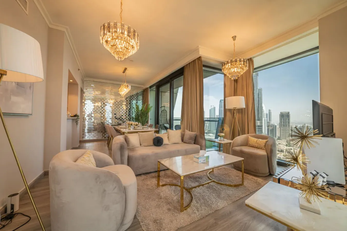 A bright living room with seating, a coffee table, and floor-to-ceiling windows.