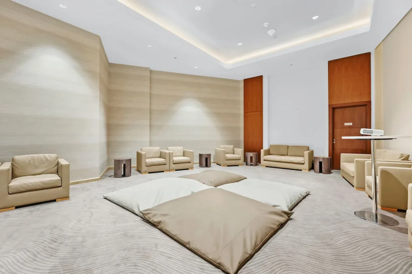 A spacious lounge with low floor cushions and seating arranged around the room.