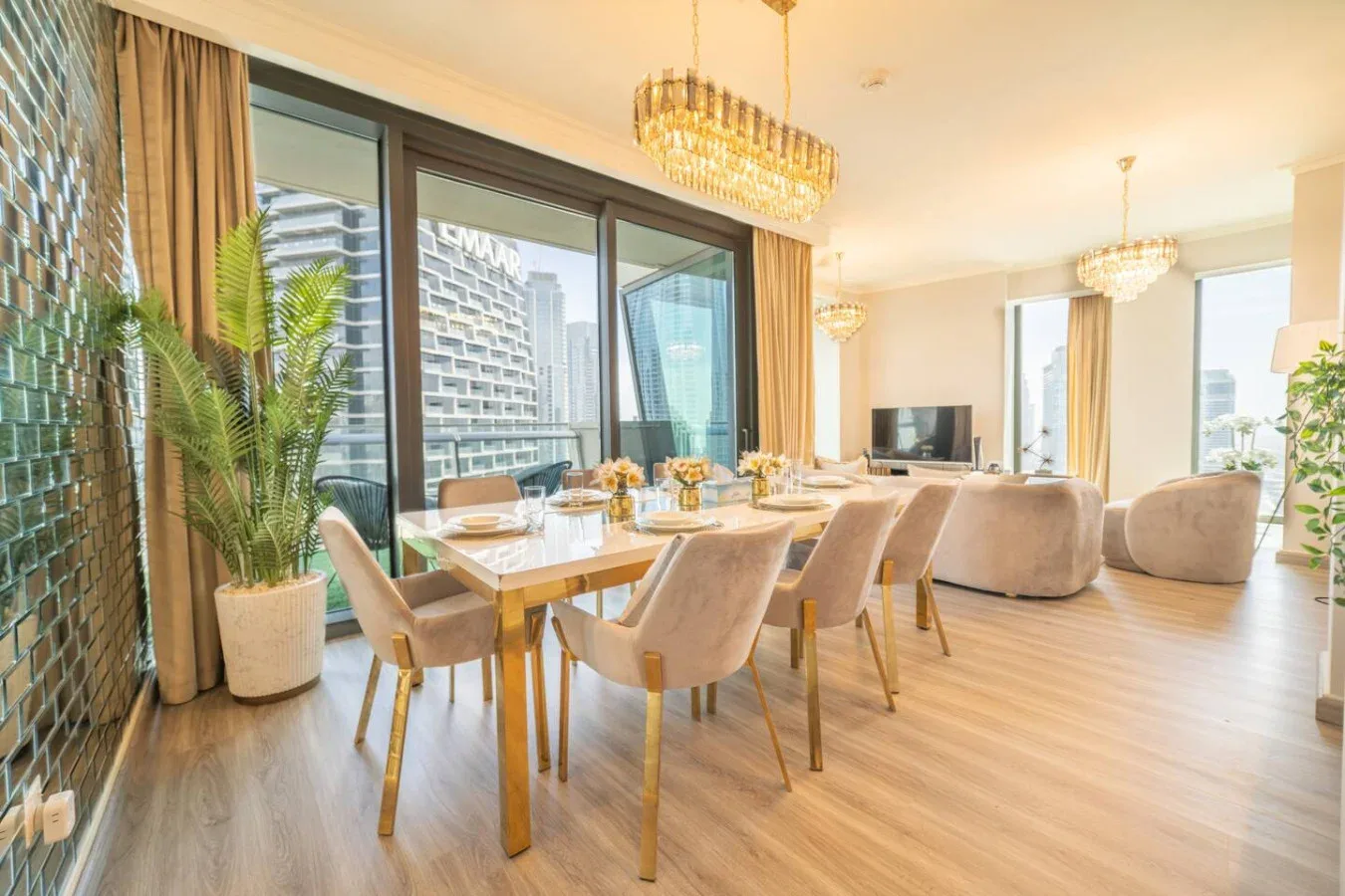 A bright dining and living area with a table beside large windows.