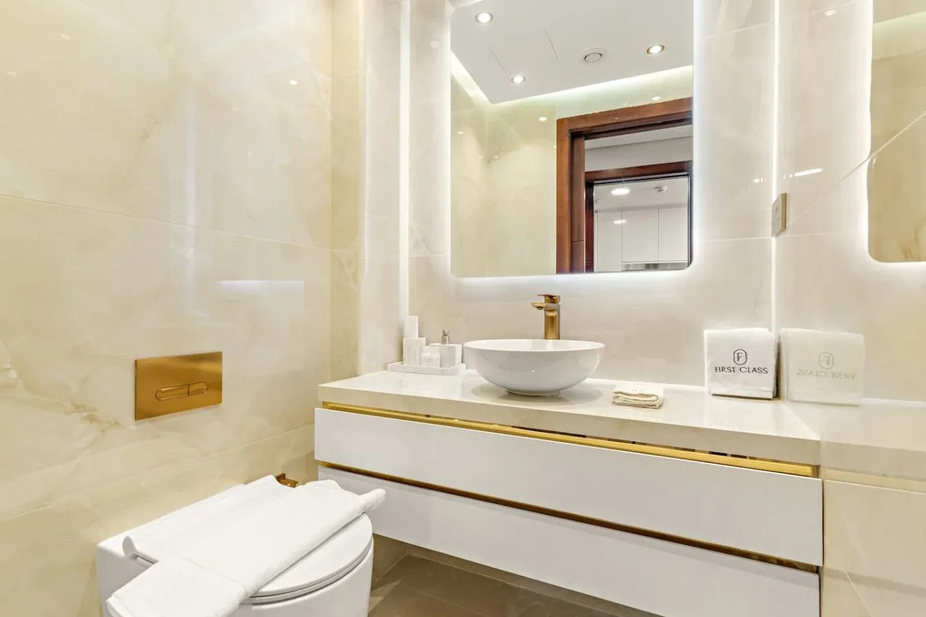 A bright bathroom with a sink vanity and a toilet.
