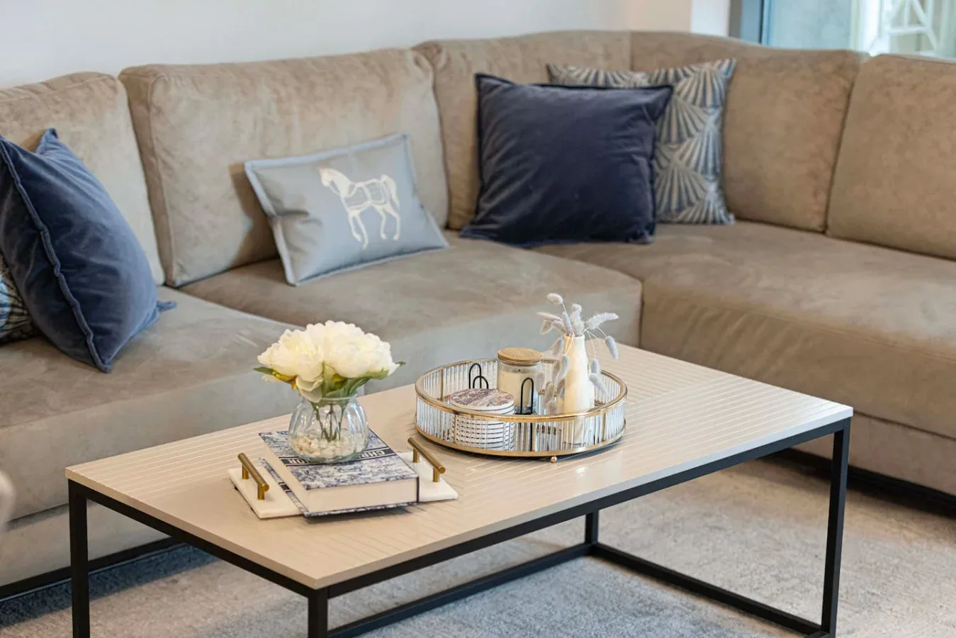 A living room with a sectional seating area and a coffee table.