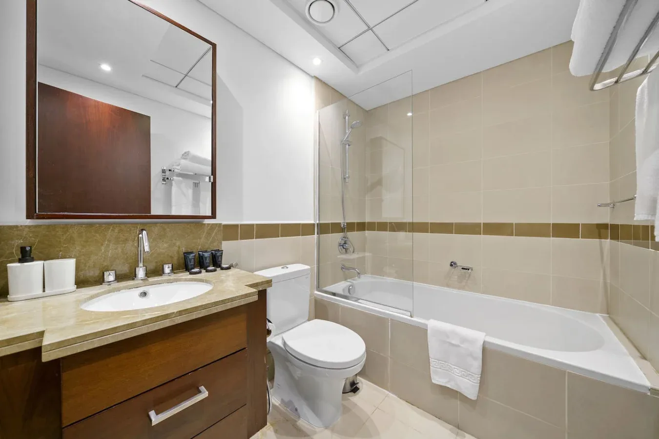 A bathroom with a sink, toilet, and bathtub.