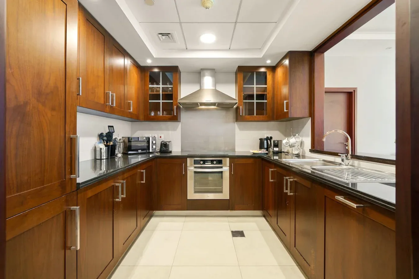 A kitchen with wooden cabinets, countertops, and a central oven.