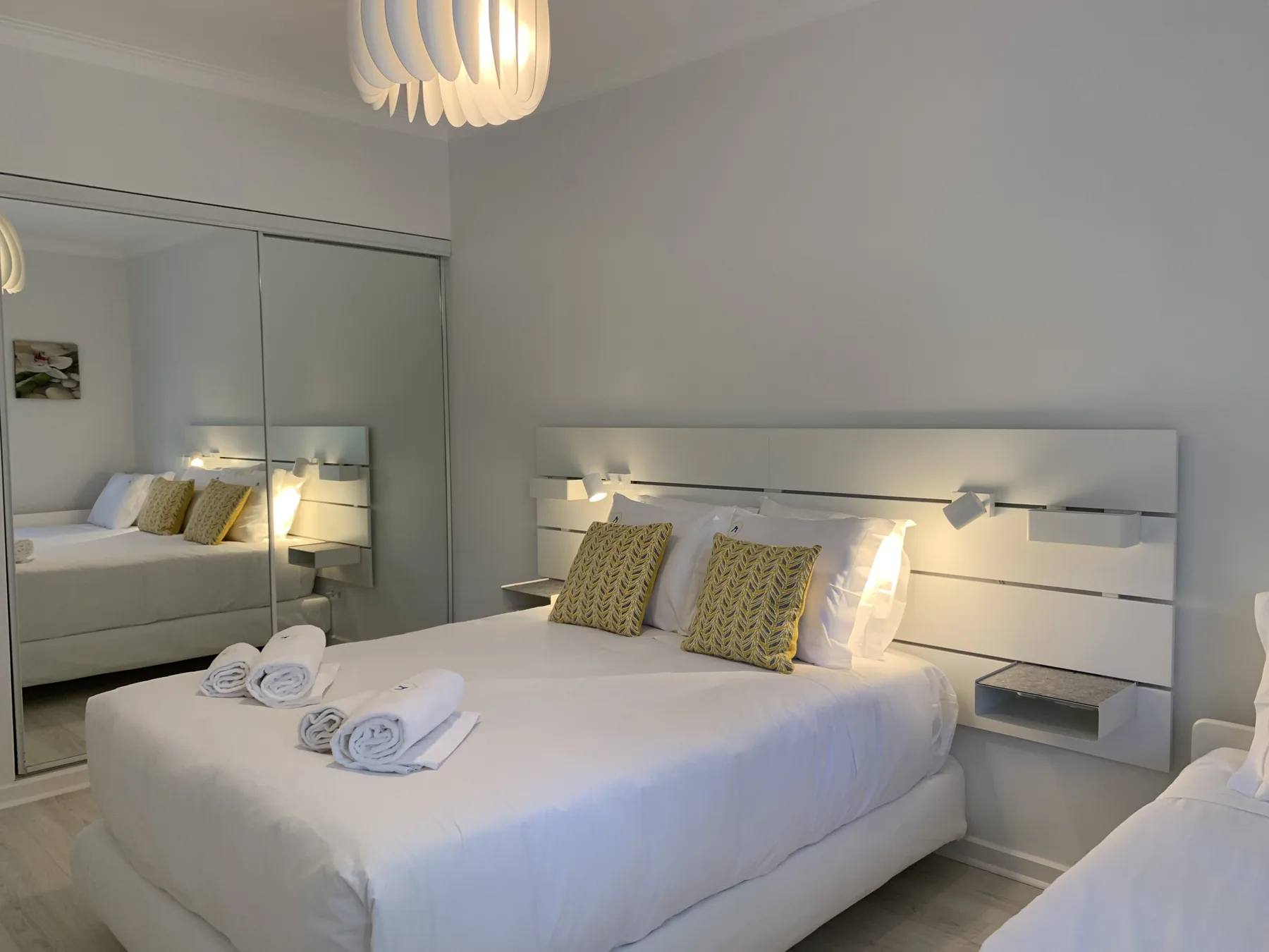 Dormitorio con una cama bien hecha y almohadas estampadas.