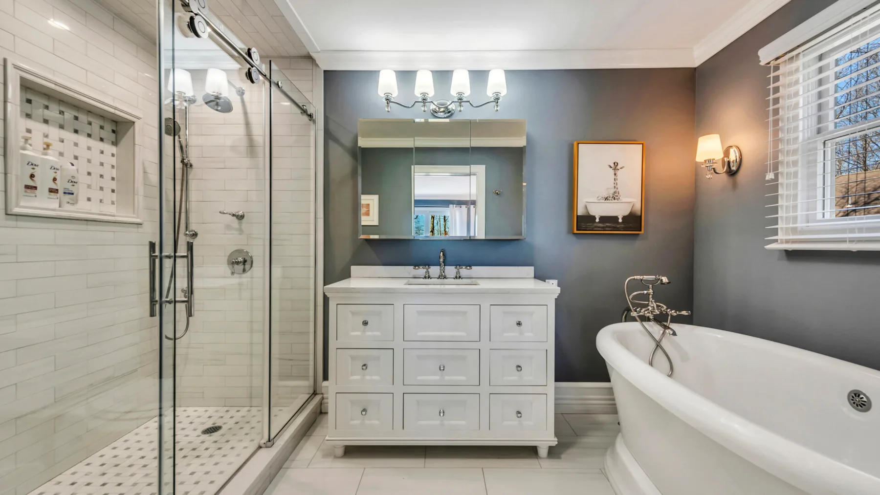 A bathroom with a glass shower, vanity, and freestanding bathtub.