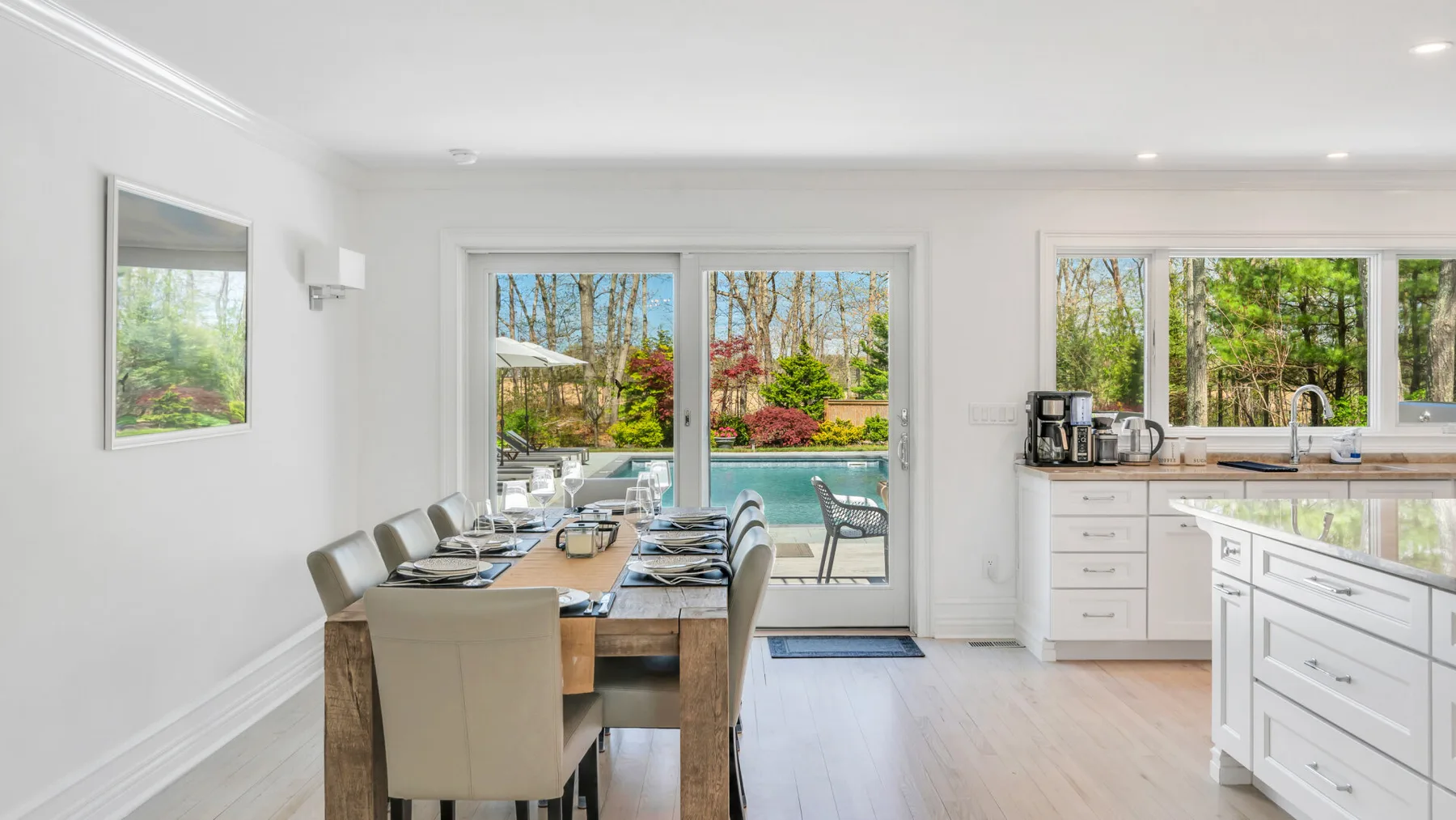 A bright dining area opens onto a patio, with a kitchen counter along the side.