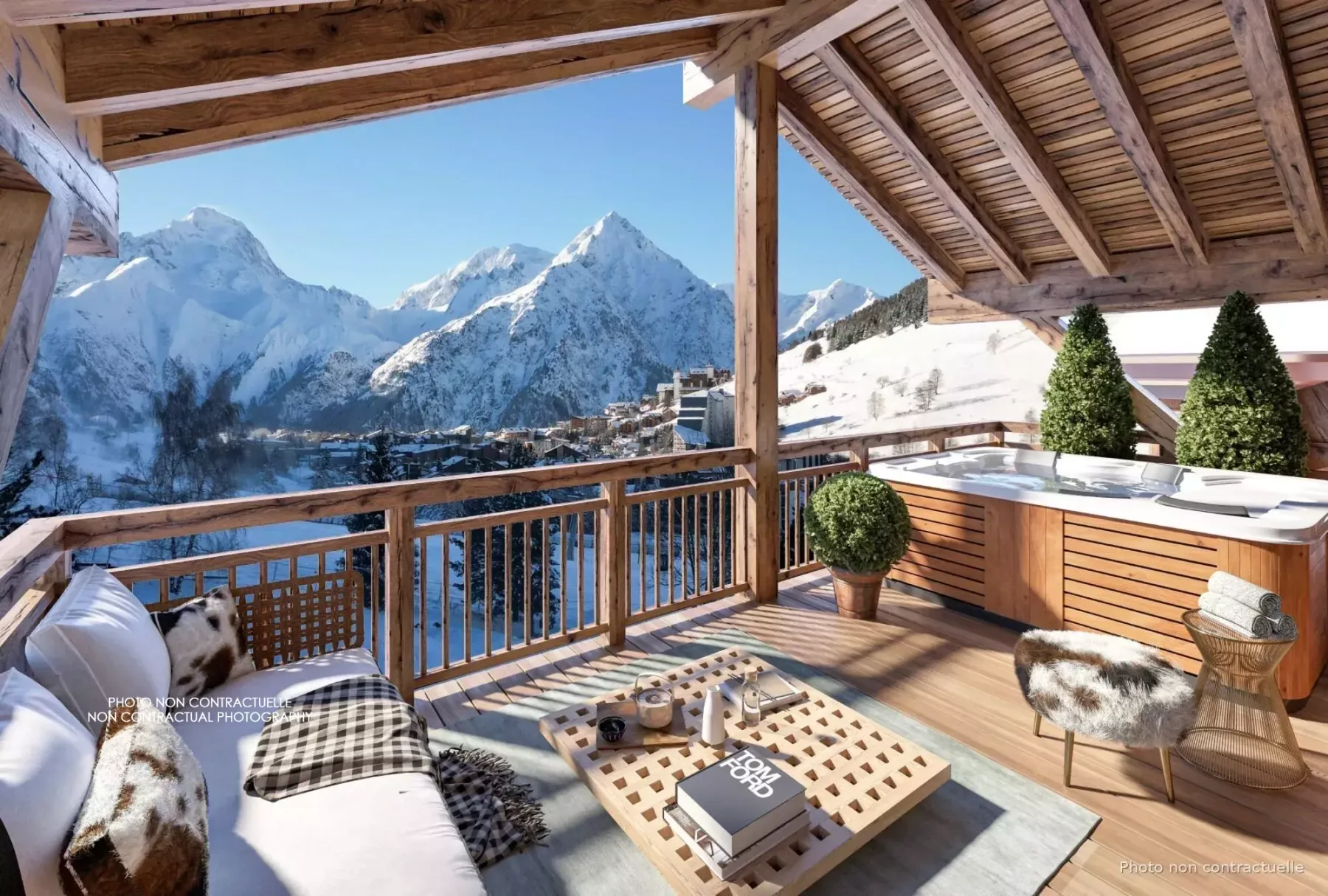 Una terraza de madera cubierta mira a un valle montañoso nevado y tiene asientos al aire libre.