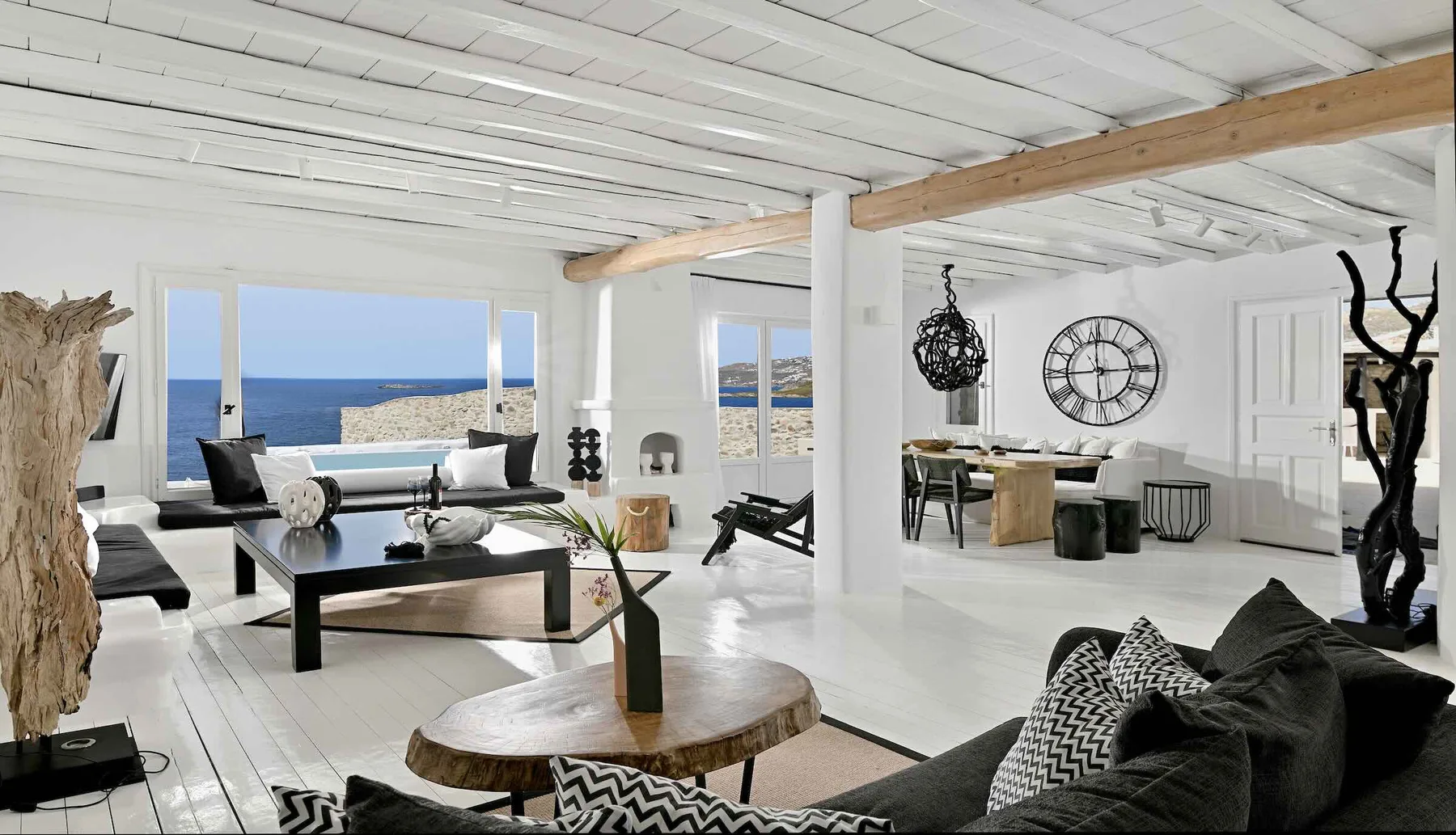 A bright open-plan living and dining room overlooks the sea.