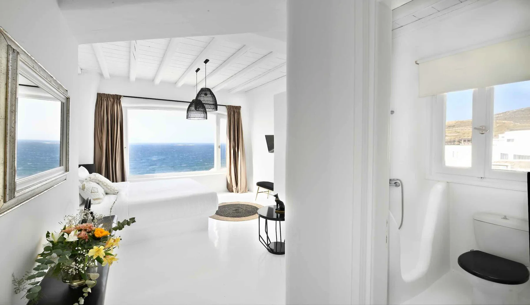 A bright white interior opens onto views of the sea.