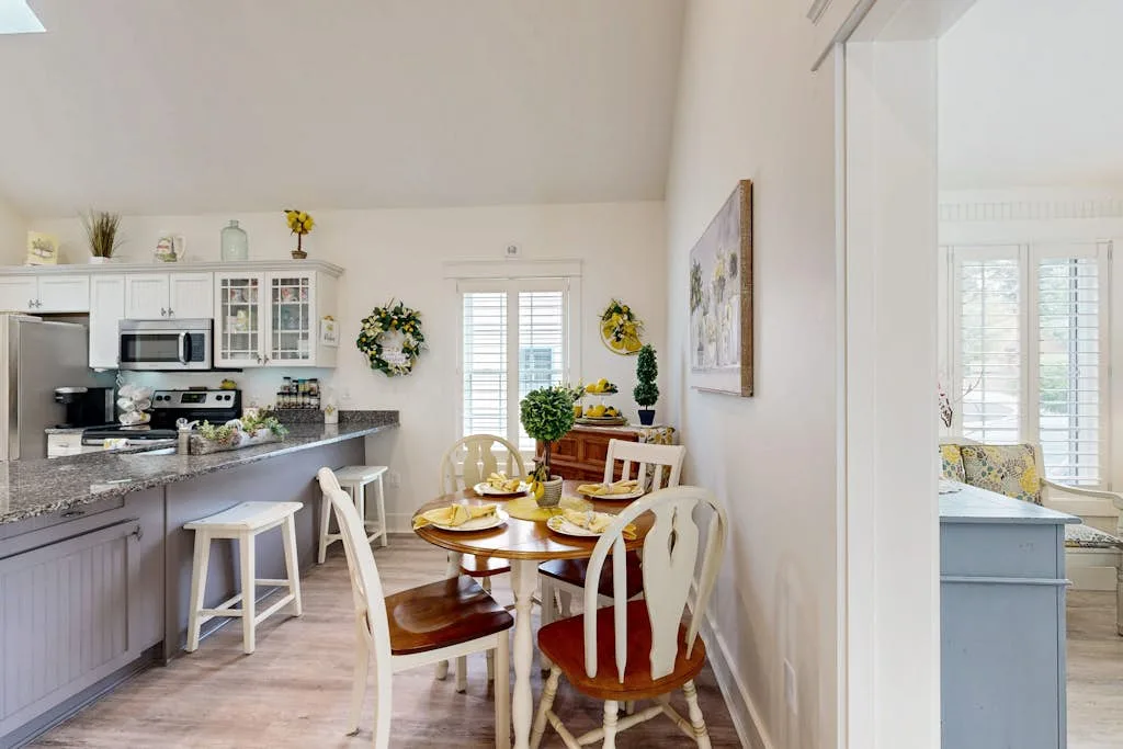 A bright kitchen and dining area with a table set for a meal.