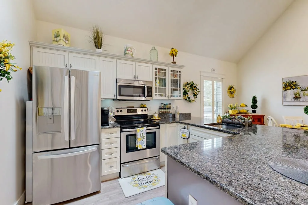 A bright kitchen with stainless steel appliances and a large island.