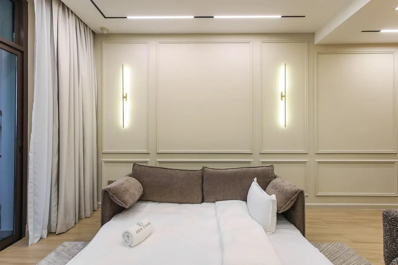 Un dormitorio con una cama bajo paneles decorativos y apliques de pared.