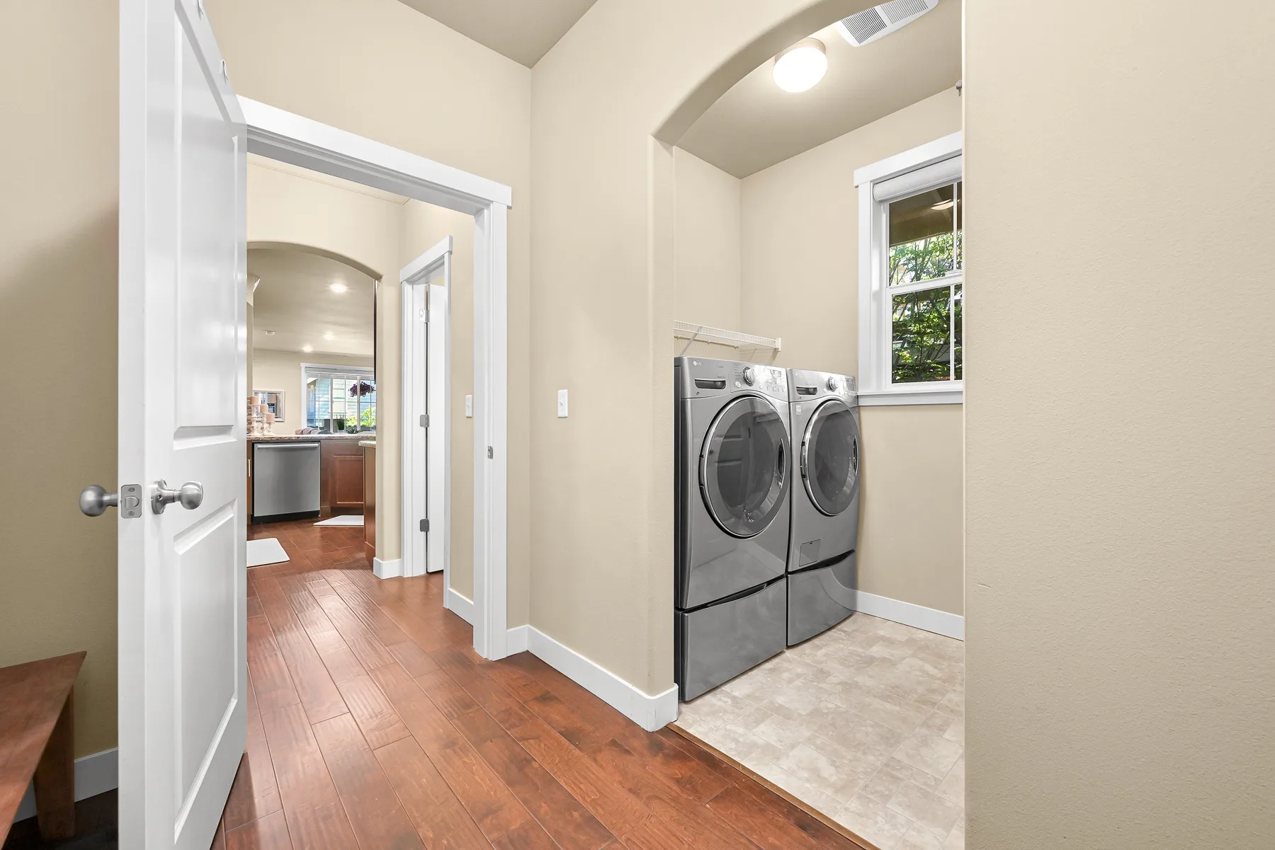 A laundry area with two front-loading machines beside a doorway.