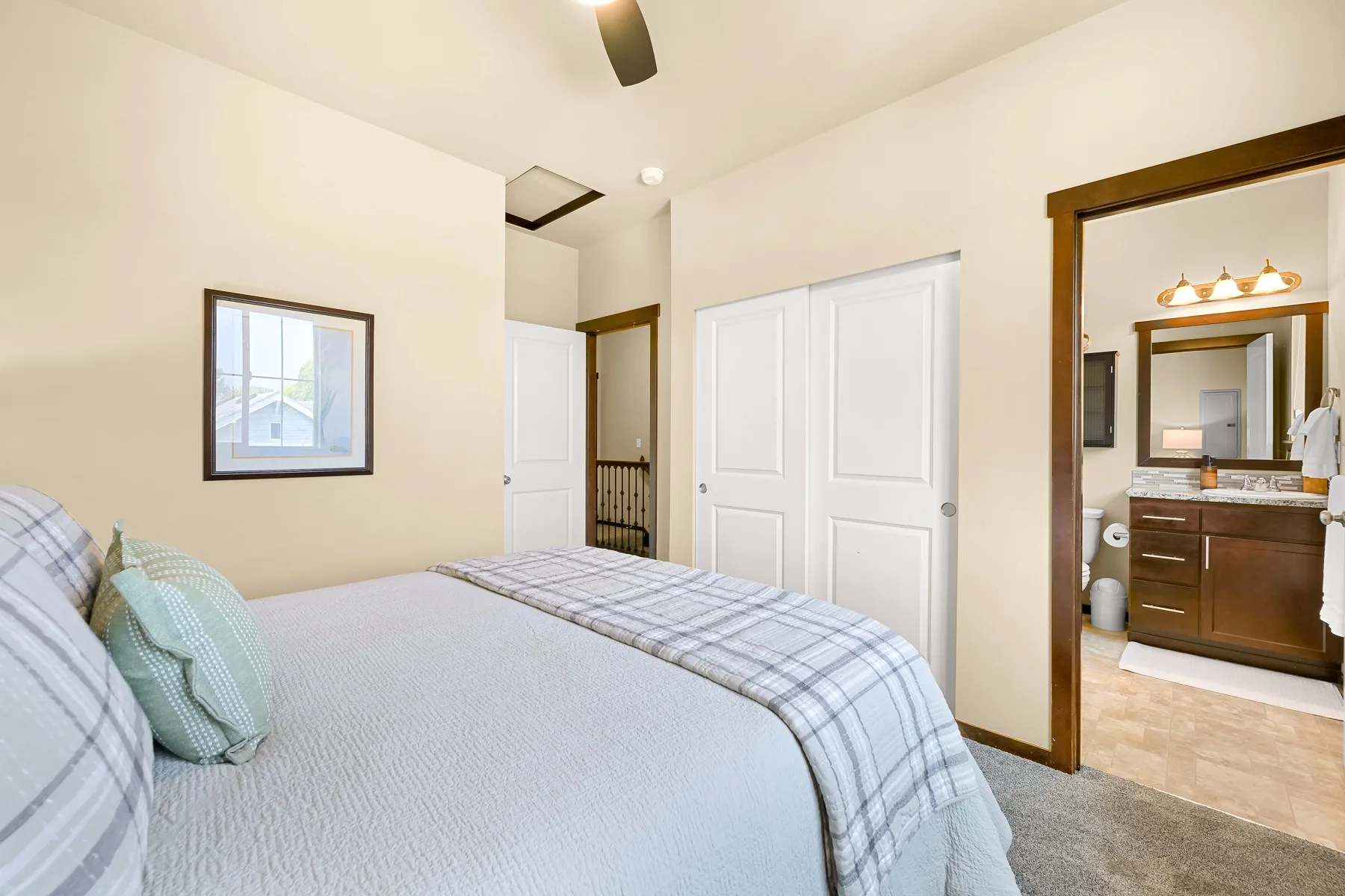 A bedroom with a bed beside a doorway to a bathroom.