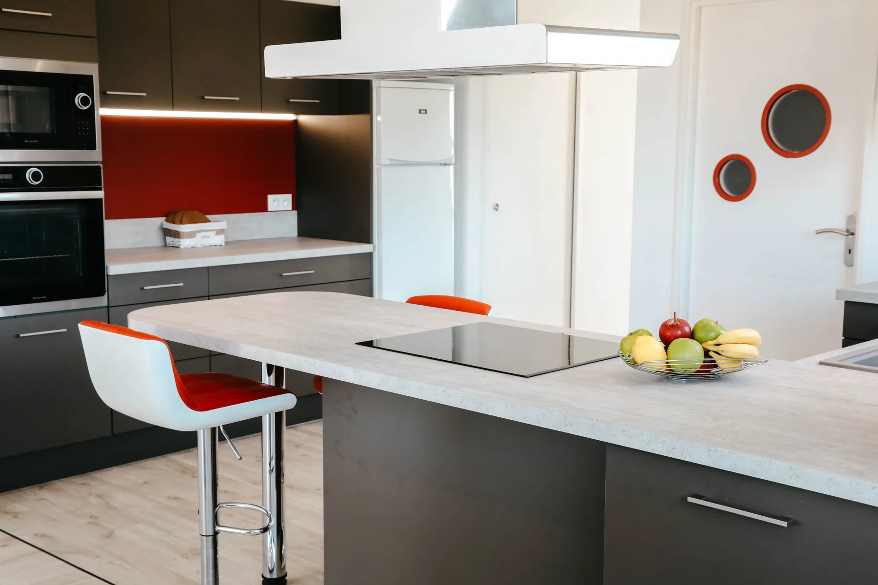 Modern kitchen with a wide island, cooktop, and bar seating.